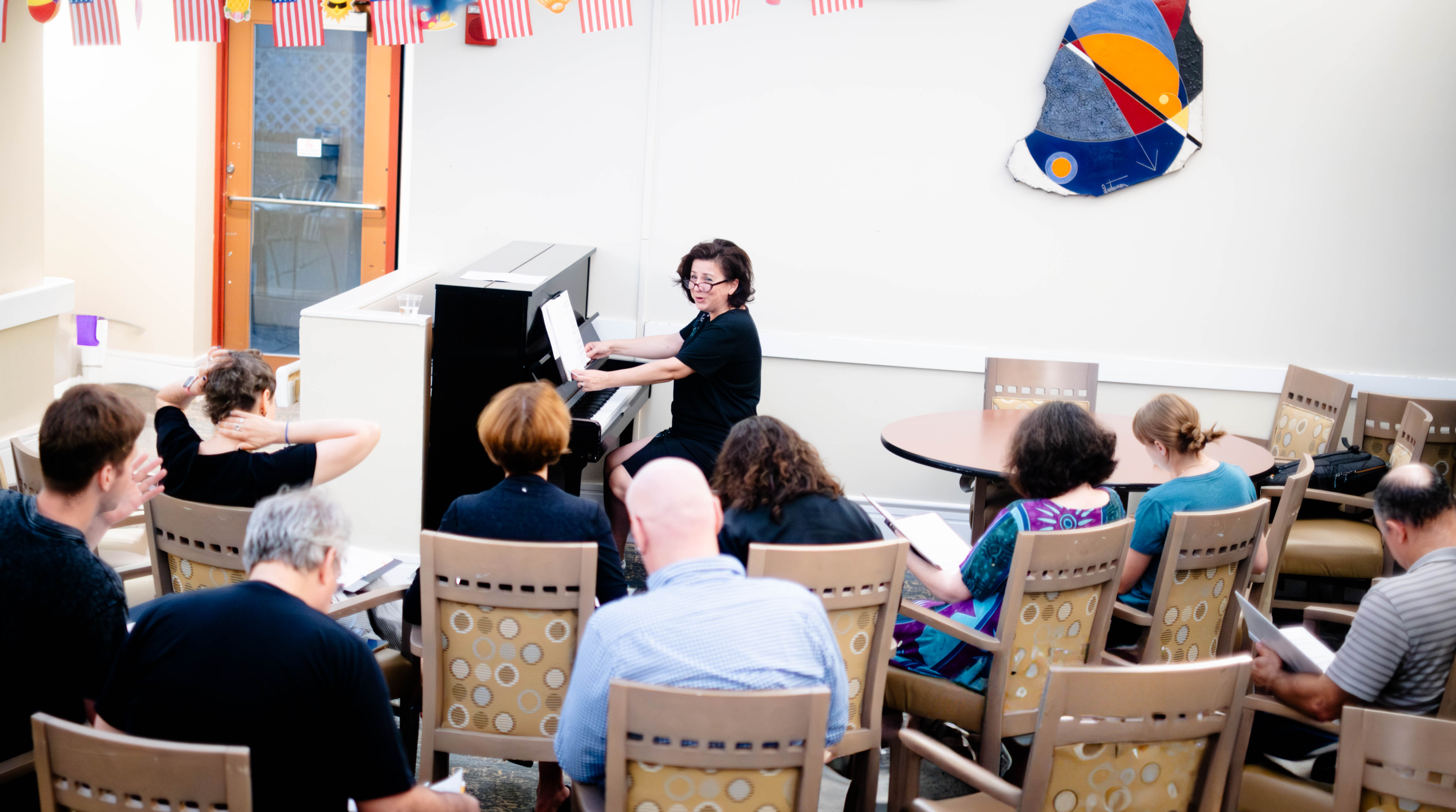 Elena Karpii conducting choir rehearsal at piano